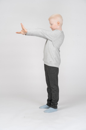 Little boy with both arms outstretched