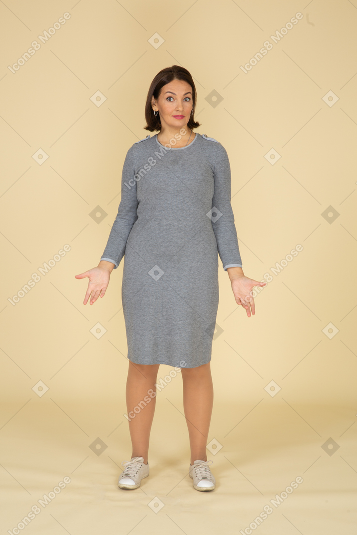 Front view of a woman in grey dress looking at camera