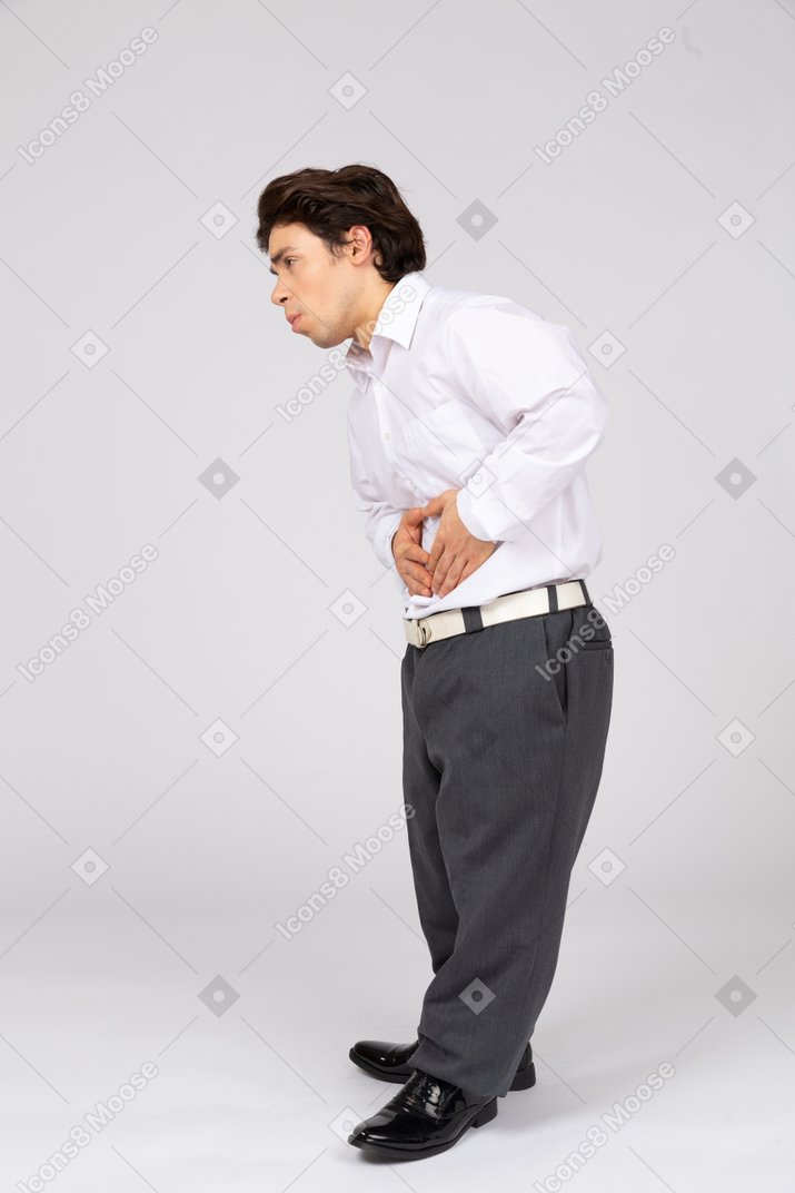 Side view of man feeling stomachache