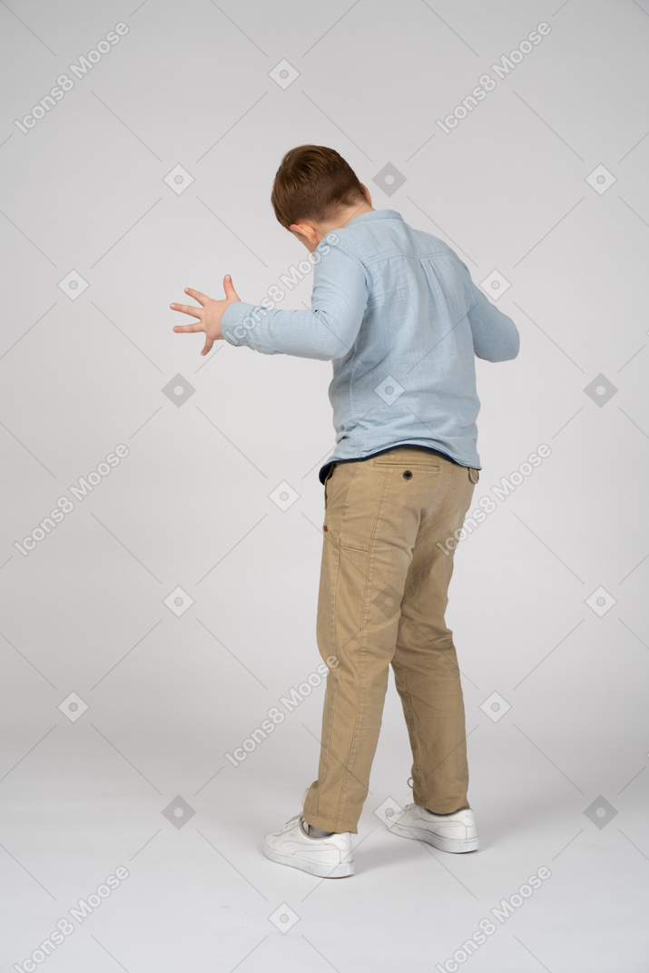 Back view of boy bending his arms