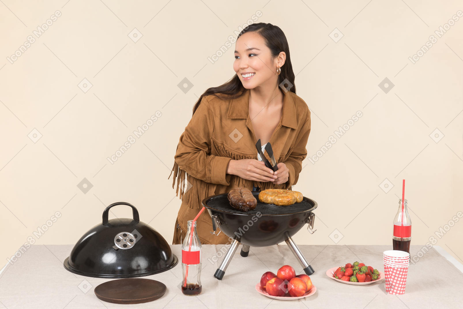 Laughing young asian woman doing bbq