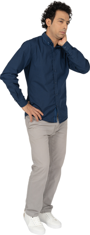 Front view of a man in casual clothes thinking about something