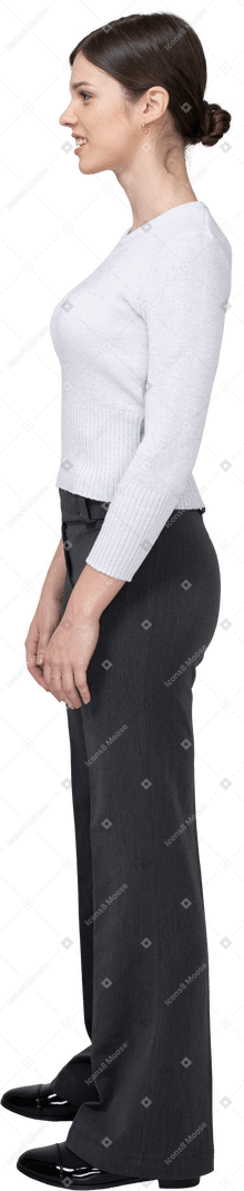 Side view of a young woman in office clothing clenching teeth