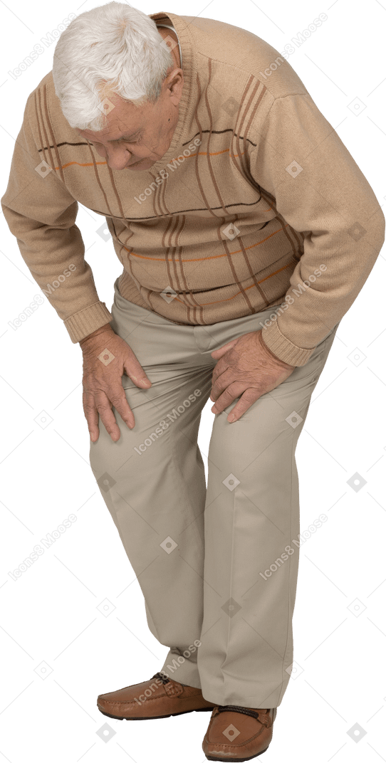 Front view of an old man in casual clothes bending down