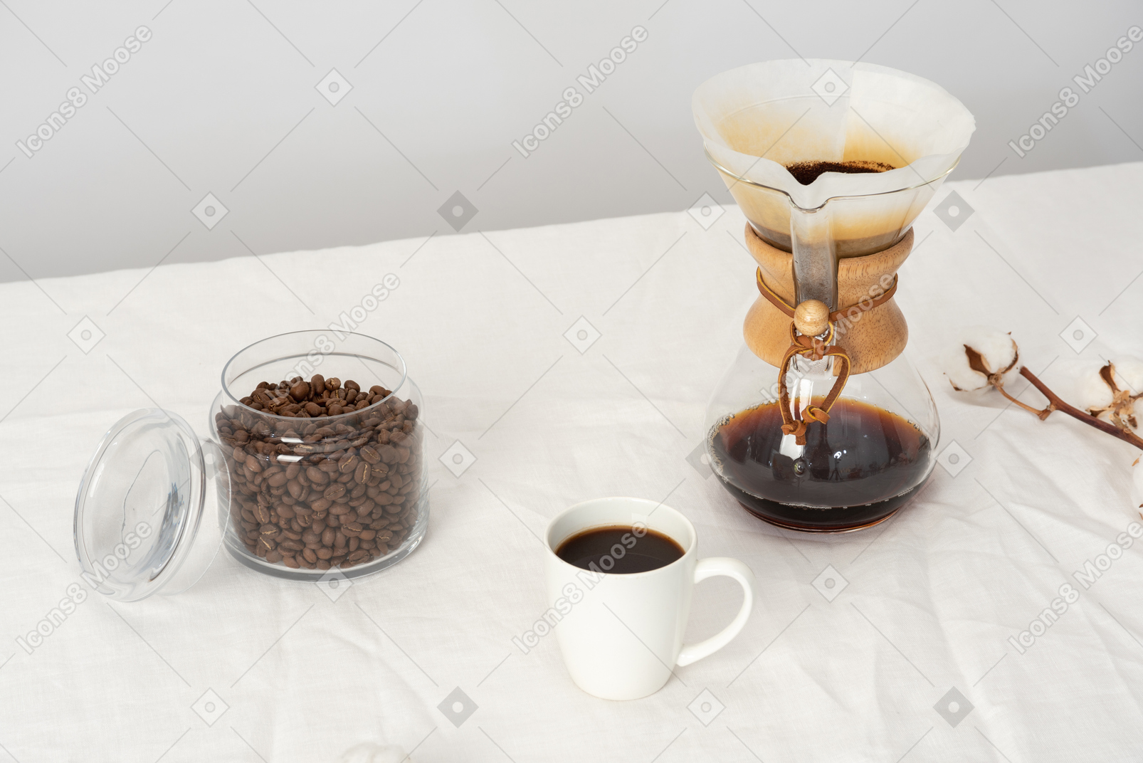 Chemex, cup of coffee and jar with coffee beans