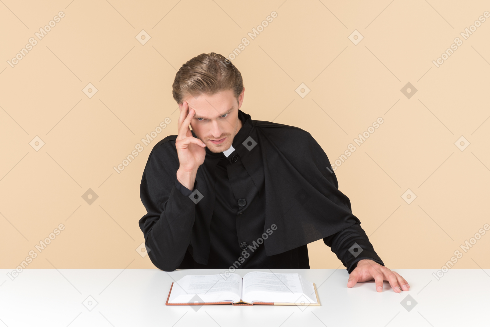 Pensive catholic priest sitting in front of open bible