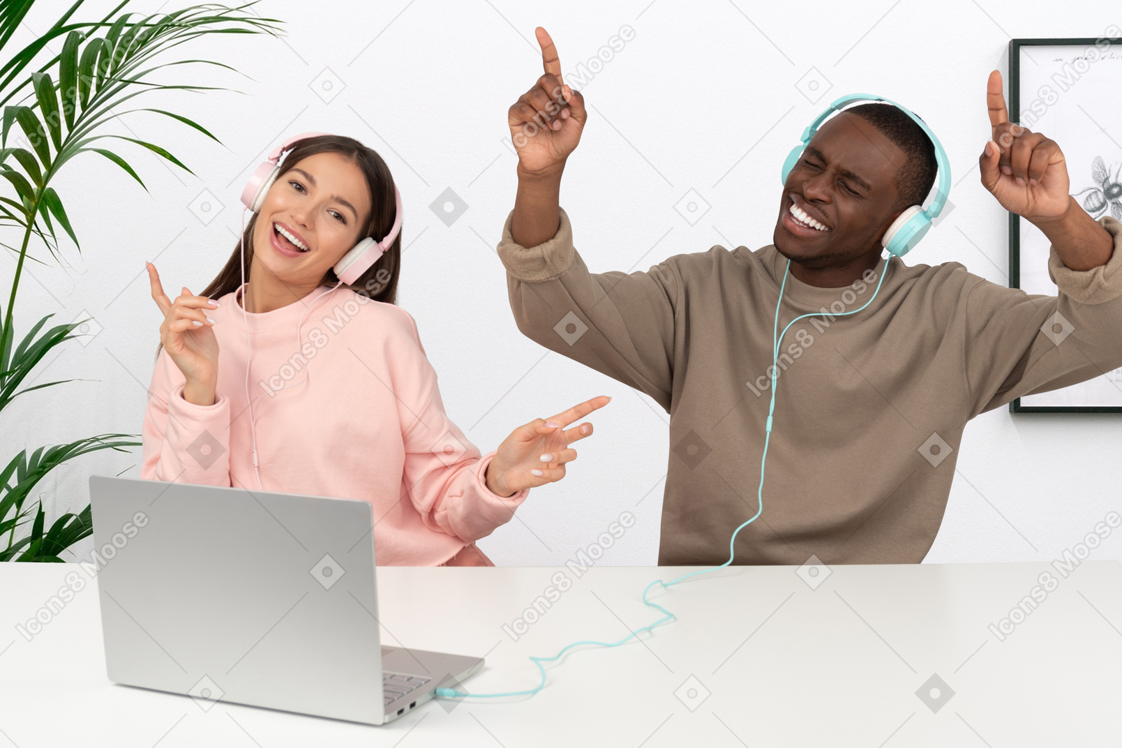 A man and a woman listening to music from laptop