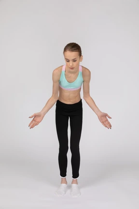 Side view of a teen girl in sportswear raising hand and arguing