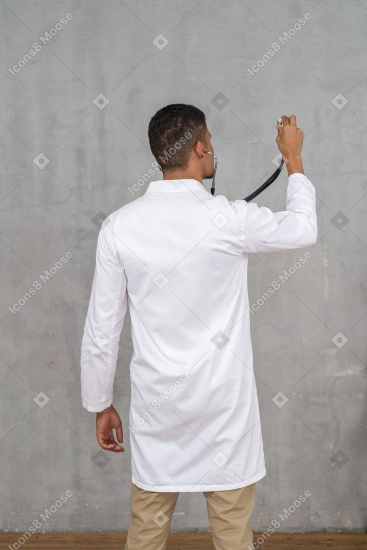 Back view of a male doctor with a stethoscope
