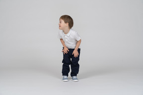 Front view of boy leaning forward and looking aside