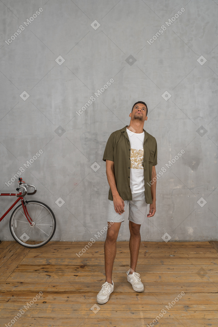 Man in casual clothes looking up