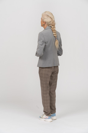 Rear view of an old lady in grey jacket