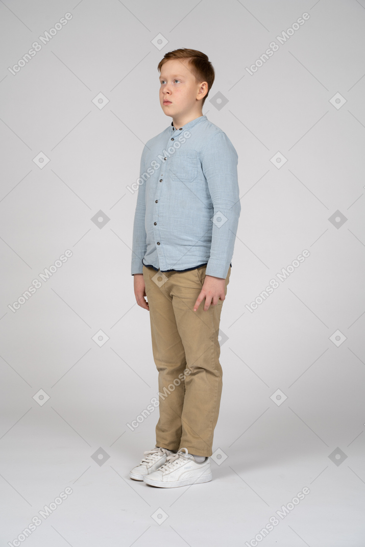 Boy standing with neutral face