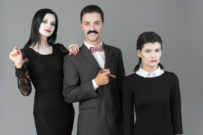 Addams family standing together
