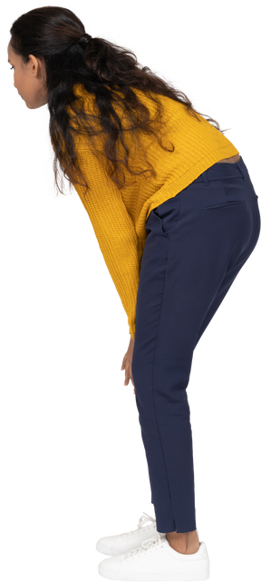 Side view of a girl in casual clothes bending down