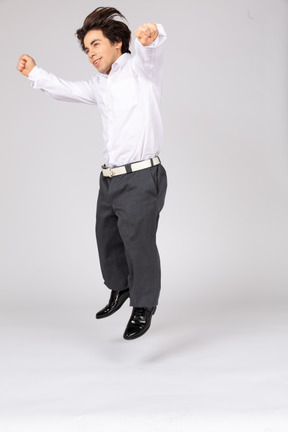 Young man jumping with spread arms