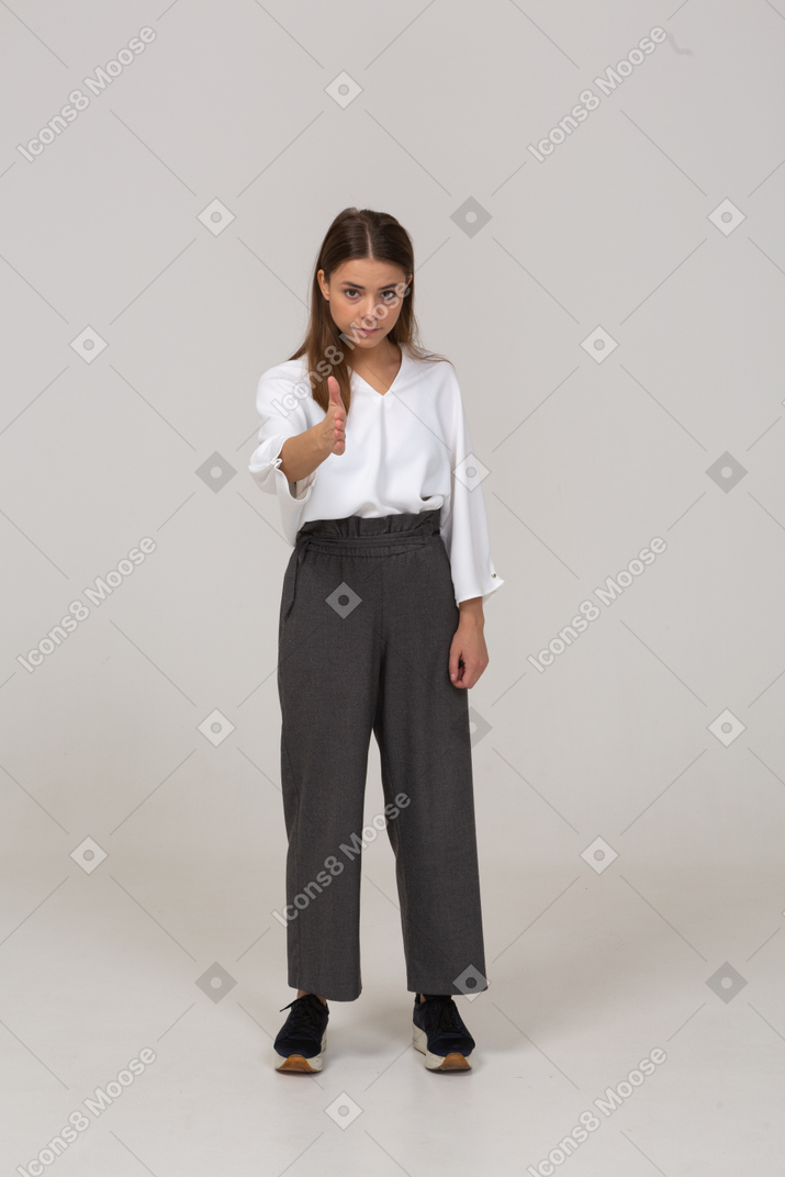 Front view of a young lady in office clothing showing the right direction