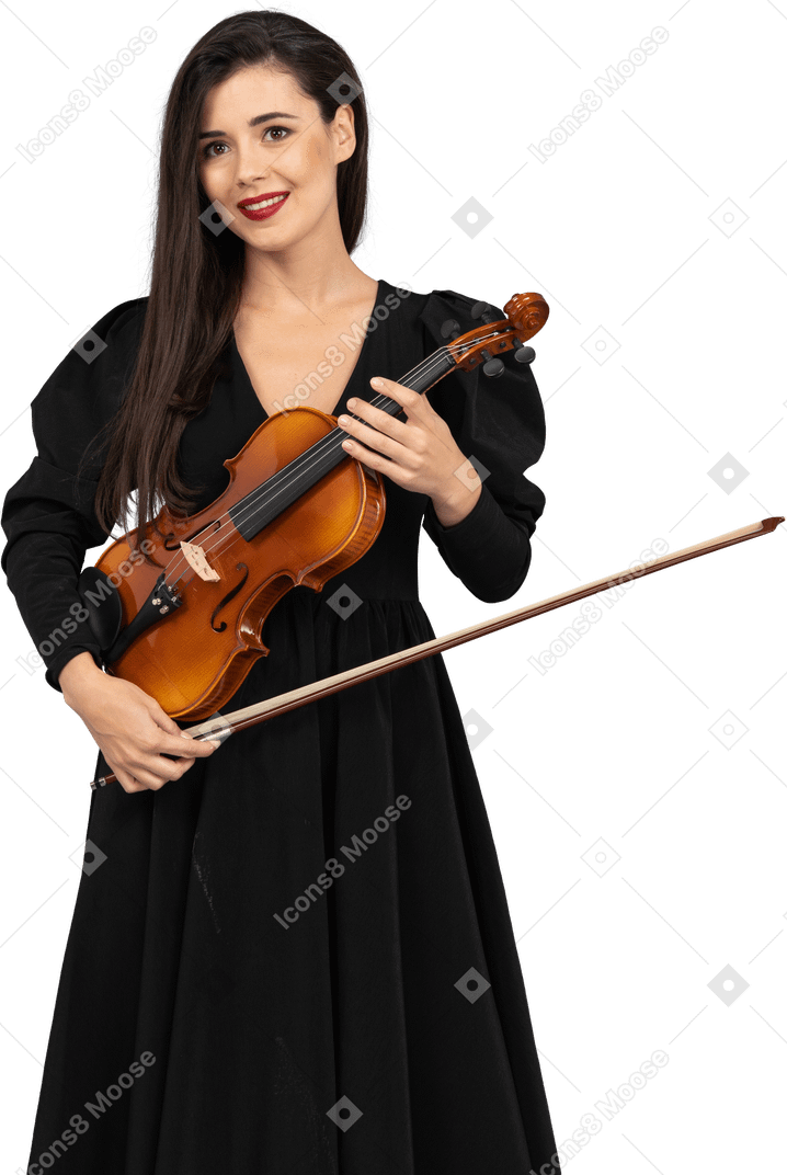 Close-up of a cheerful young lady in black dress holding the violin