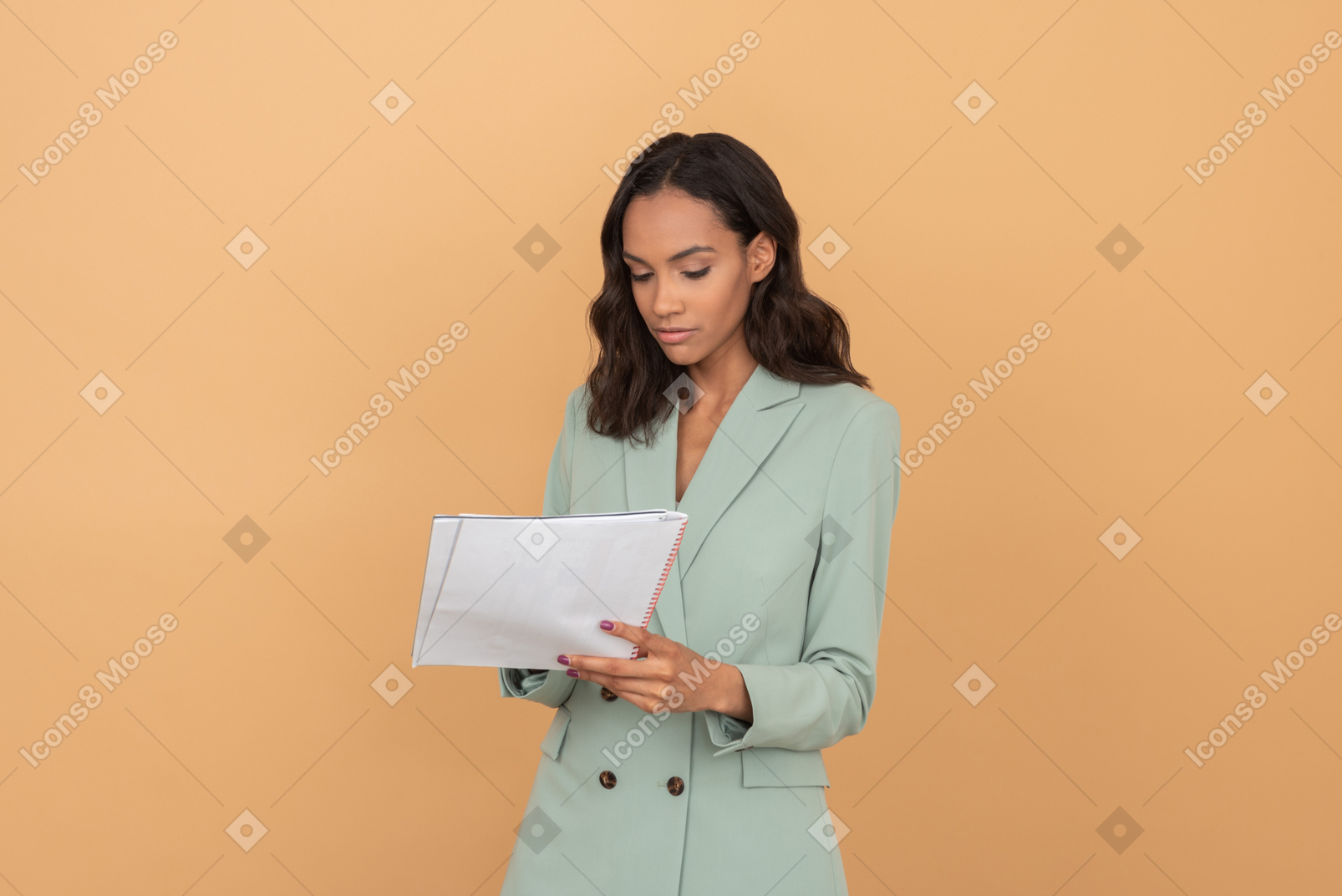 Attractive young office worker reading some papers