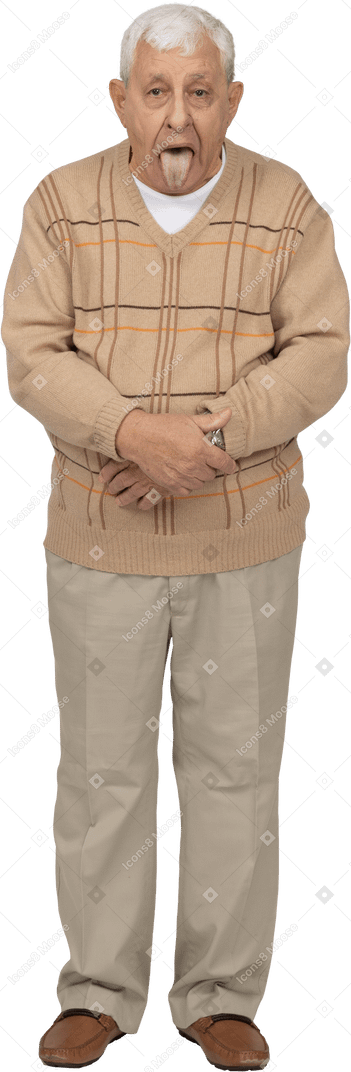 Front view of an old man in casual clothes showing tongue