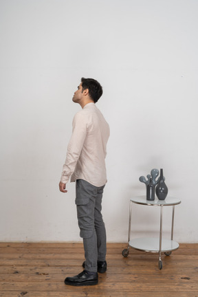 Man in casual clothes standing in profile