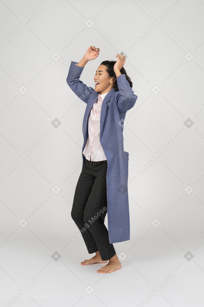 Excited woman raising hands
