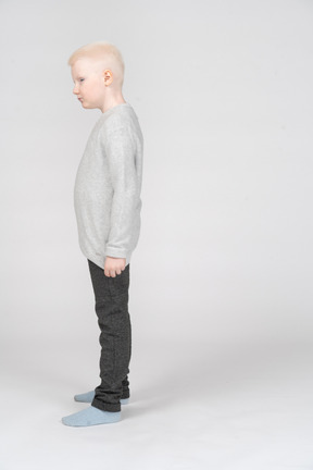 Side view of a kid boy in casual clothes looking aside