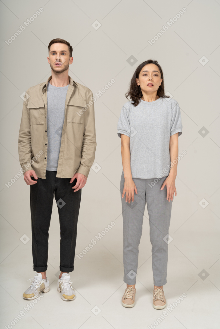 Front view of scared young couple