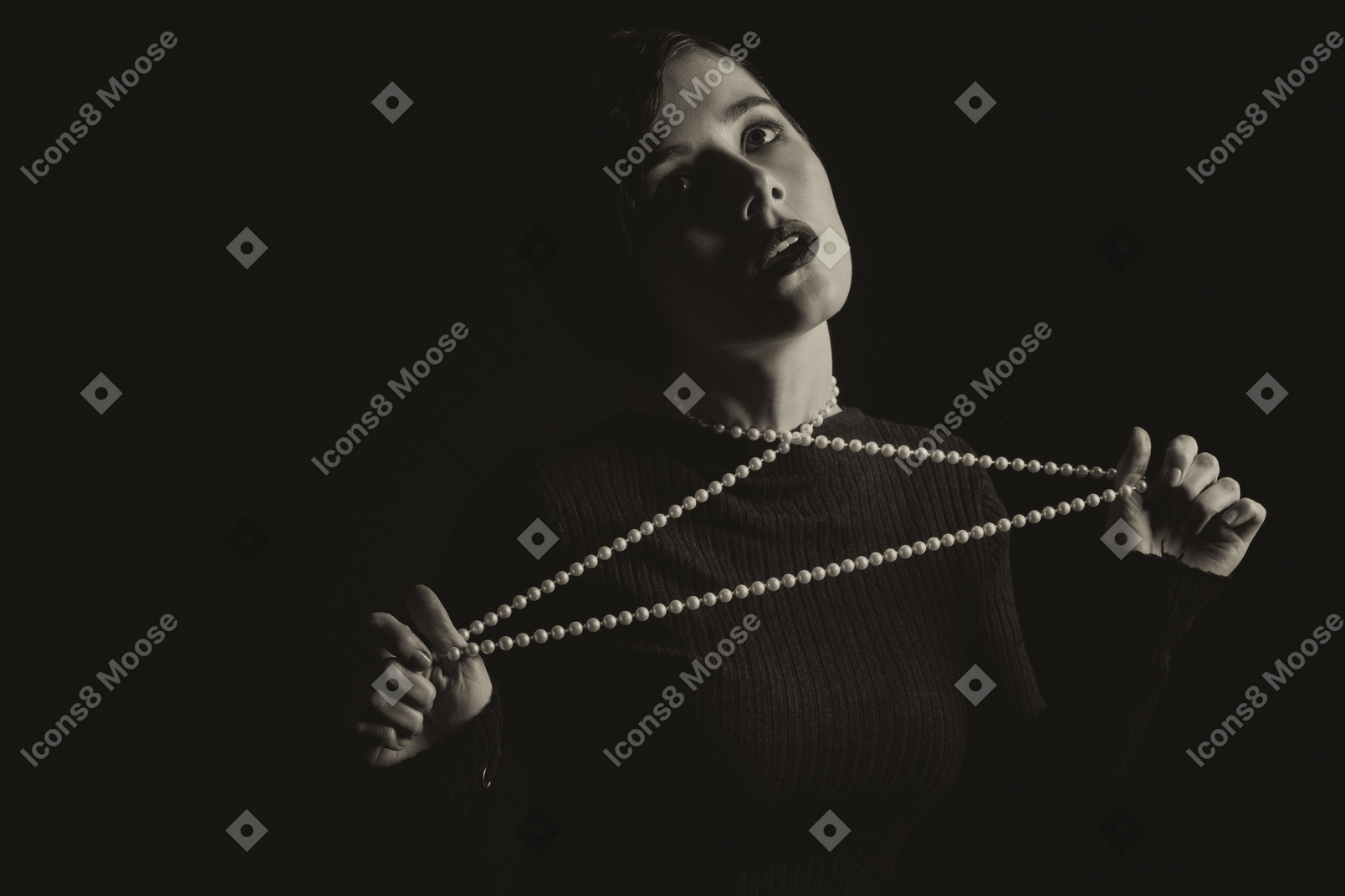 Woman tightening a string of beads on her neck