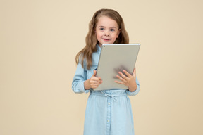 Mignonne petite fille à l'aide d'une tablette