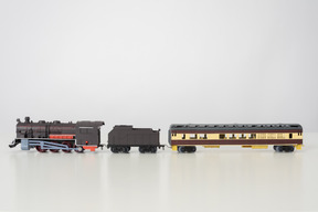 Toy trains on grey background