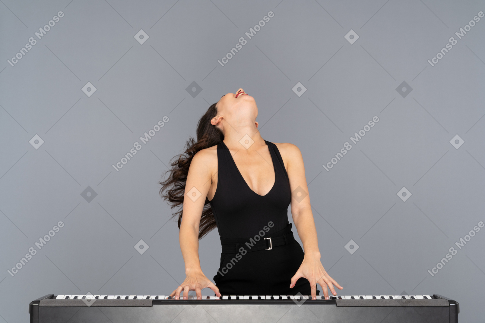 Woman bending her head back while playing a piano