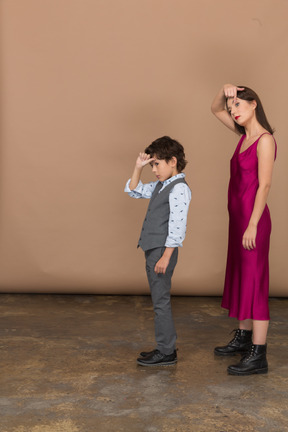 Boy and woman widening their eyes