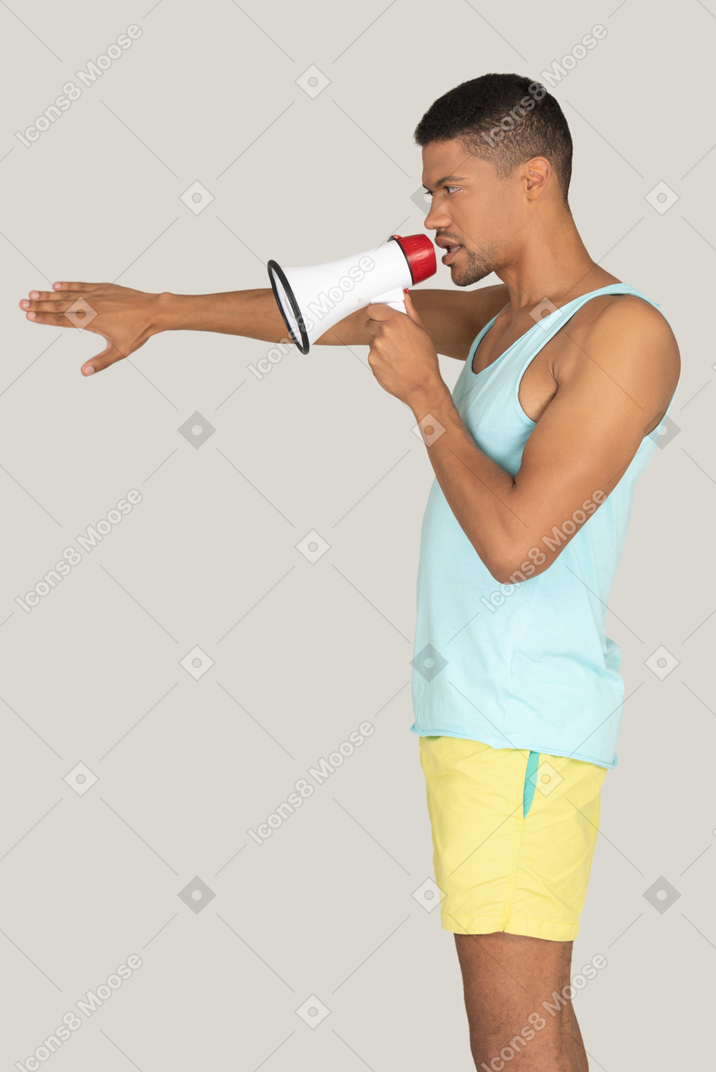 Man speaking into megaphone and pointing forward