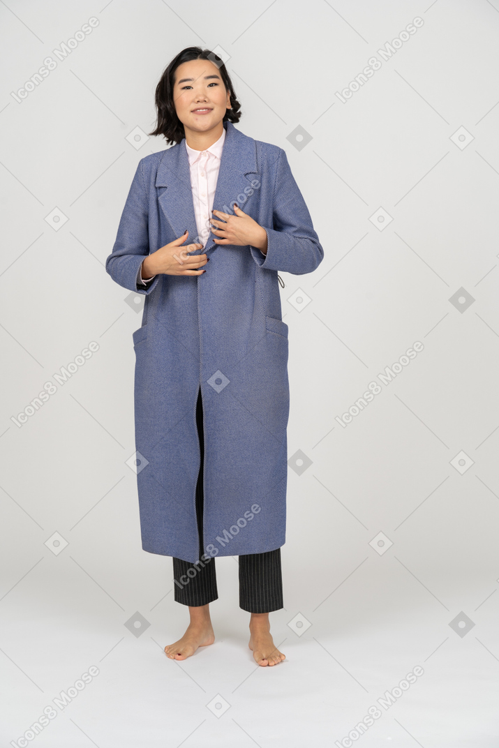 Excited smiling woman in coat looking at camera