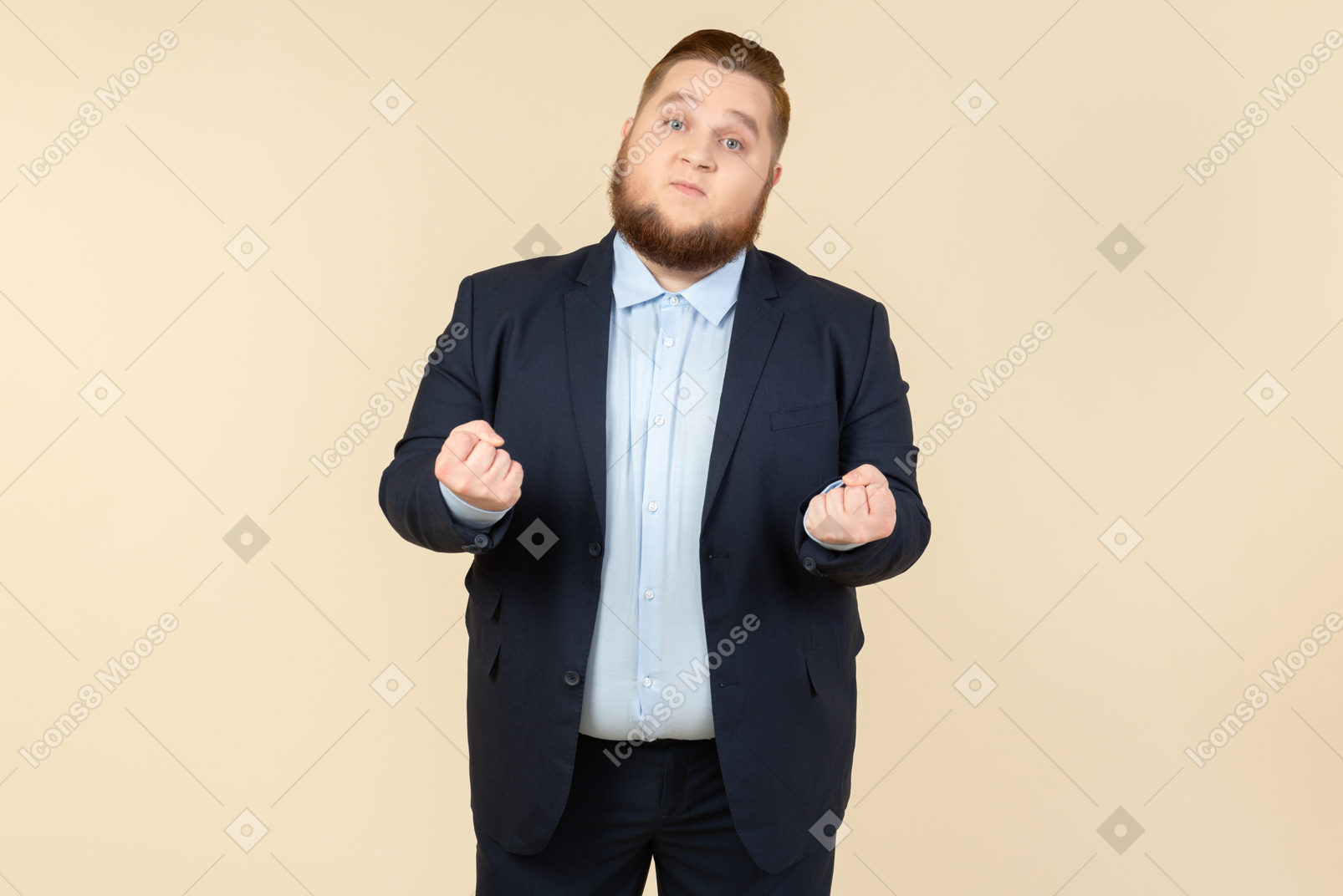 Mad looking young overweight man in suit holding fists clenched