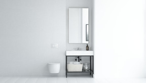 Weißes badezimmer mit wandhängender toilette und waschbecken