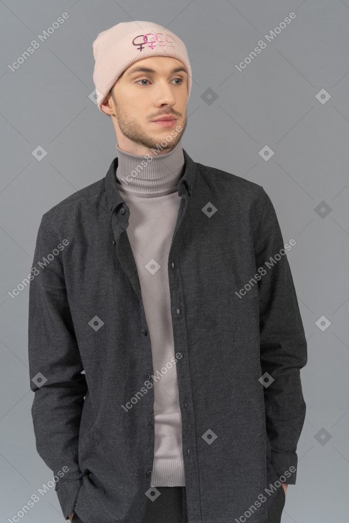 Male model on gray background wearing pink hat with female signs