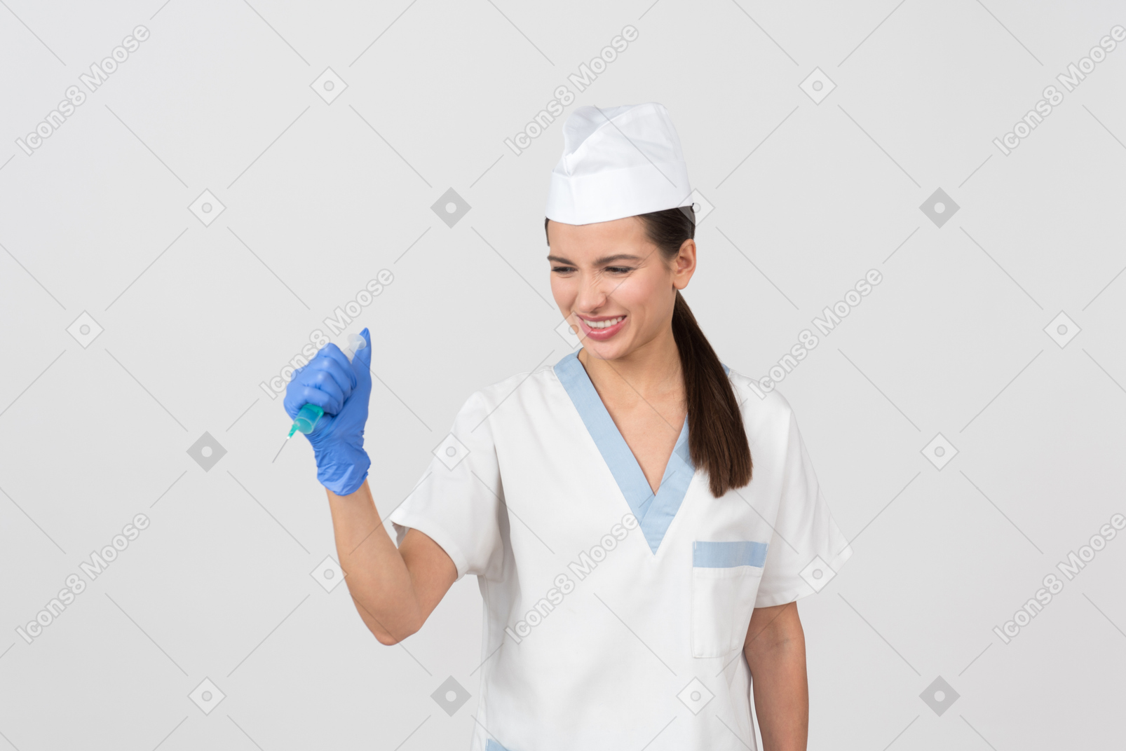 Annoyed young nurse waving a syringe