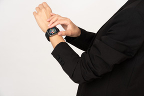 A cropped shot of a young woman wearing smartwatch