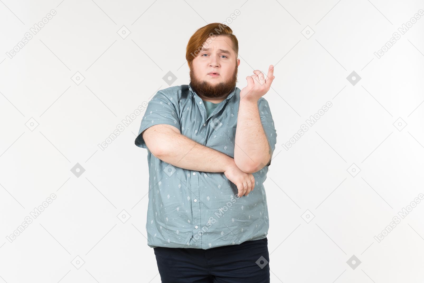Pensive young overweight man standing with hands crossed
