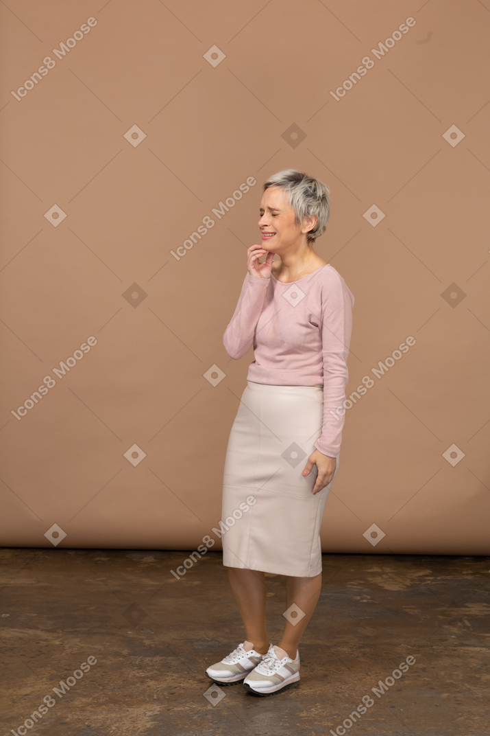 Happy woman in casual clothes touching her chin