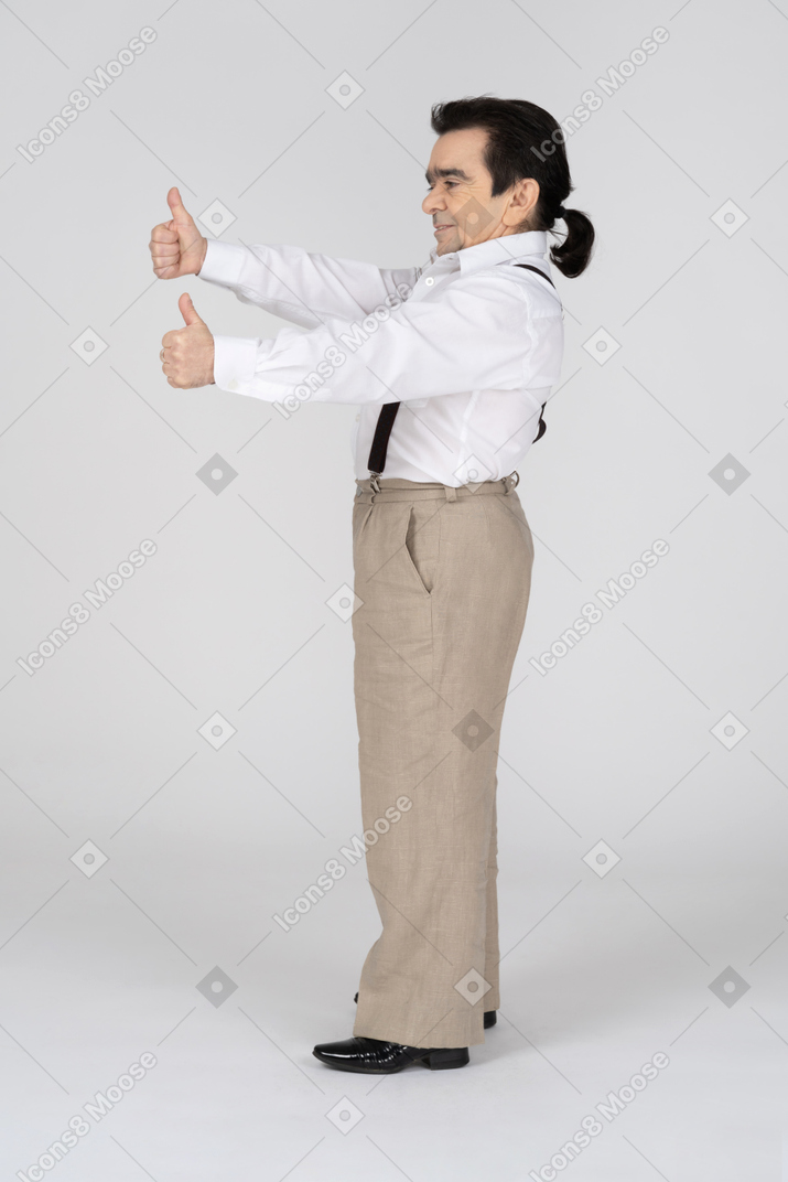 Side view of man with two thumbs up