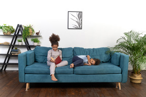 Good looking boy and girl play on the sofa