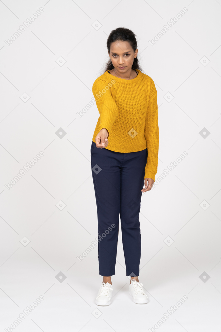 Front view of a girl in casual clothes standing with extended arm