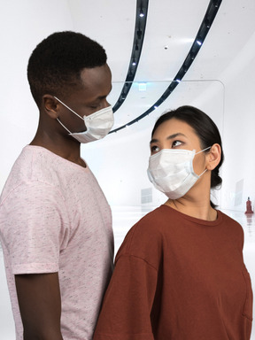 A man and a woman wearing face masks