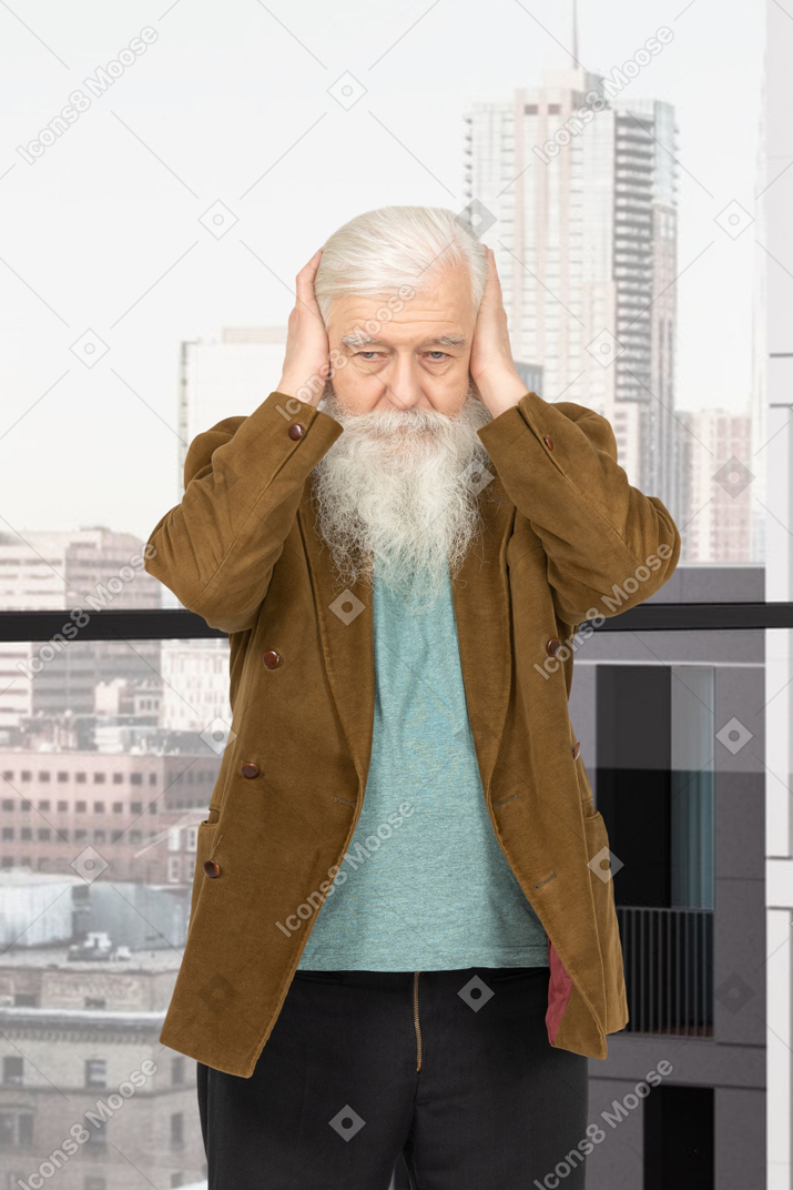 Elderly man with a long white beard covering ears