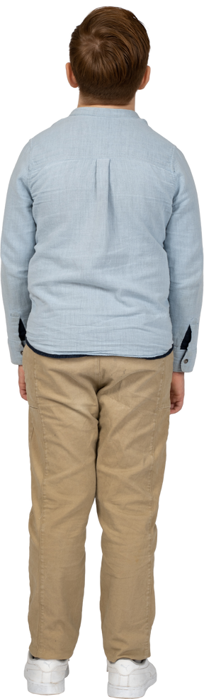Back view of a boy in casual clothes standing still