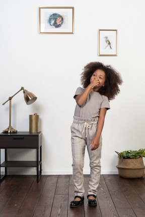 Good looking girl kid posing on the apartment background