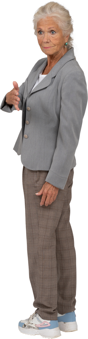 Side view of an old lady in suit giving a hand for shake